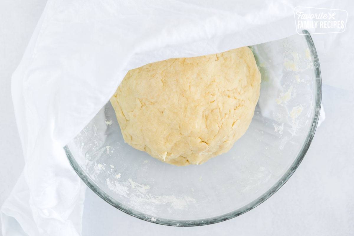 A ball of tortilla dough in a glass bowl