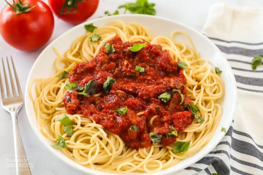 Spaghetti sauce made from fresh tomatoes over a bowl of spaghetti for Homemade Spaghetti Sauce with Fresh Tomatoes