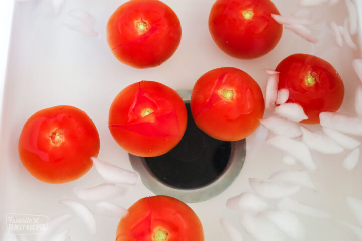 Seven tomatoes in an ice water bath