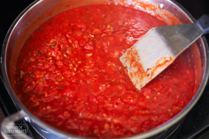Spaghetti sauce simmering in a large pan
