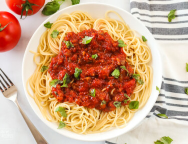 A close up of a bowl of spaghetti showing the texture of the sauce