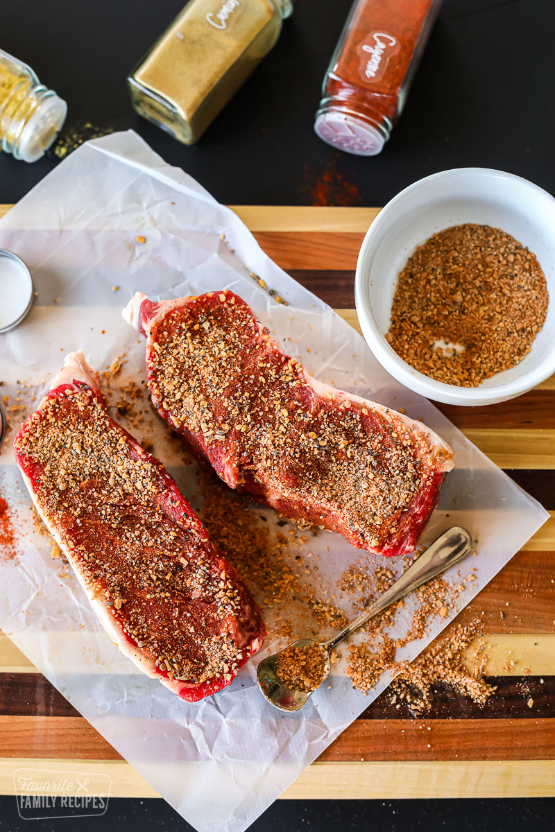 Homemade steak rub on two pieces of steak.