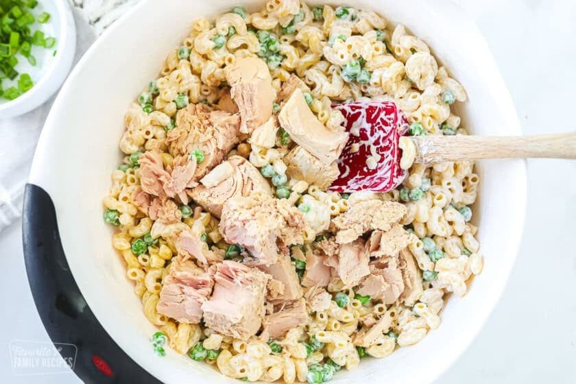 A bowl of macaroni salad with tuna added over the top.
