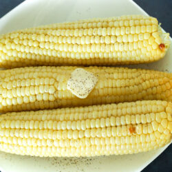 A plate of 3 cooked Air Fryer Corn on the Cob