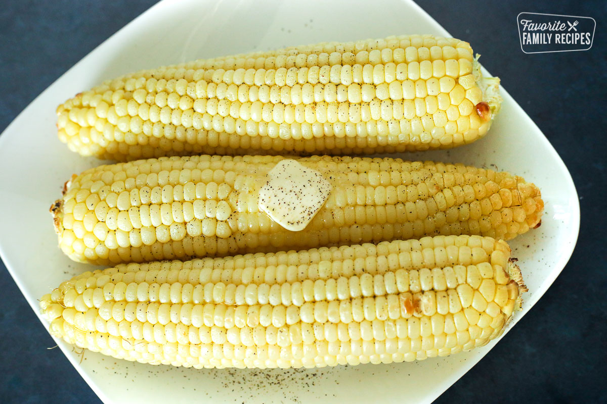 A plate of 3 cooked Air Fryer Corn on the Cob