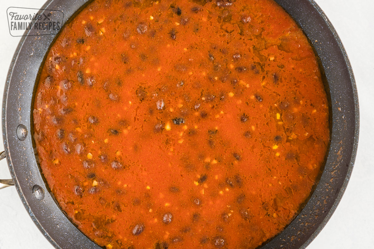 Black beans and spices in tomato juice cooking in a pot