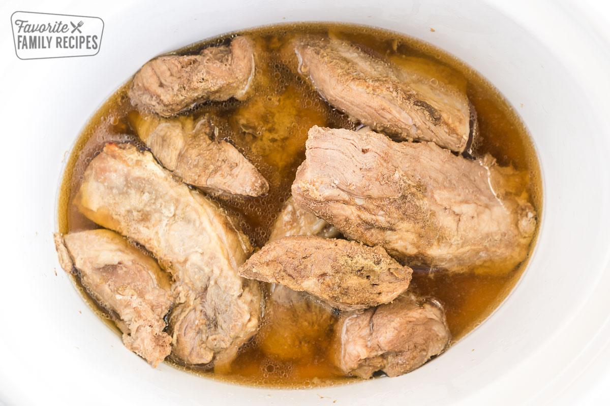 Boneless pork ribs cooking in a crock pot