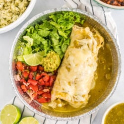 A homemade cafe rio sweet pork burrito with lettuce and pico de gallo