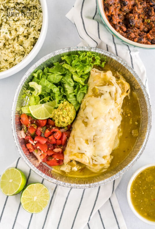 A homemade cafe rio sweet pork burrito with lettuce and pico de gallo