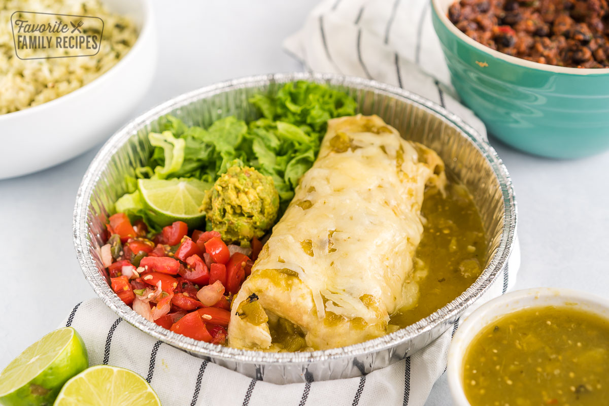 A homemade cafe rio sweet pork burrito with lettuce and pico de gallo