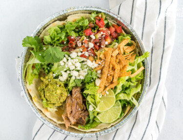 A homemade cafe rio sweet pork salad in a metal tin