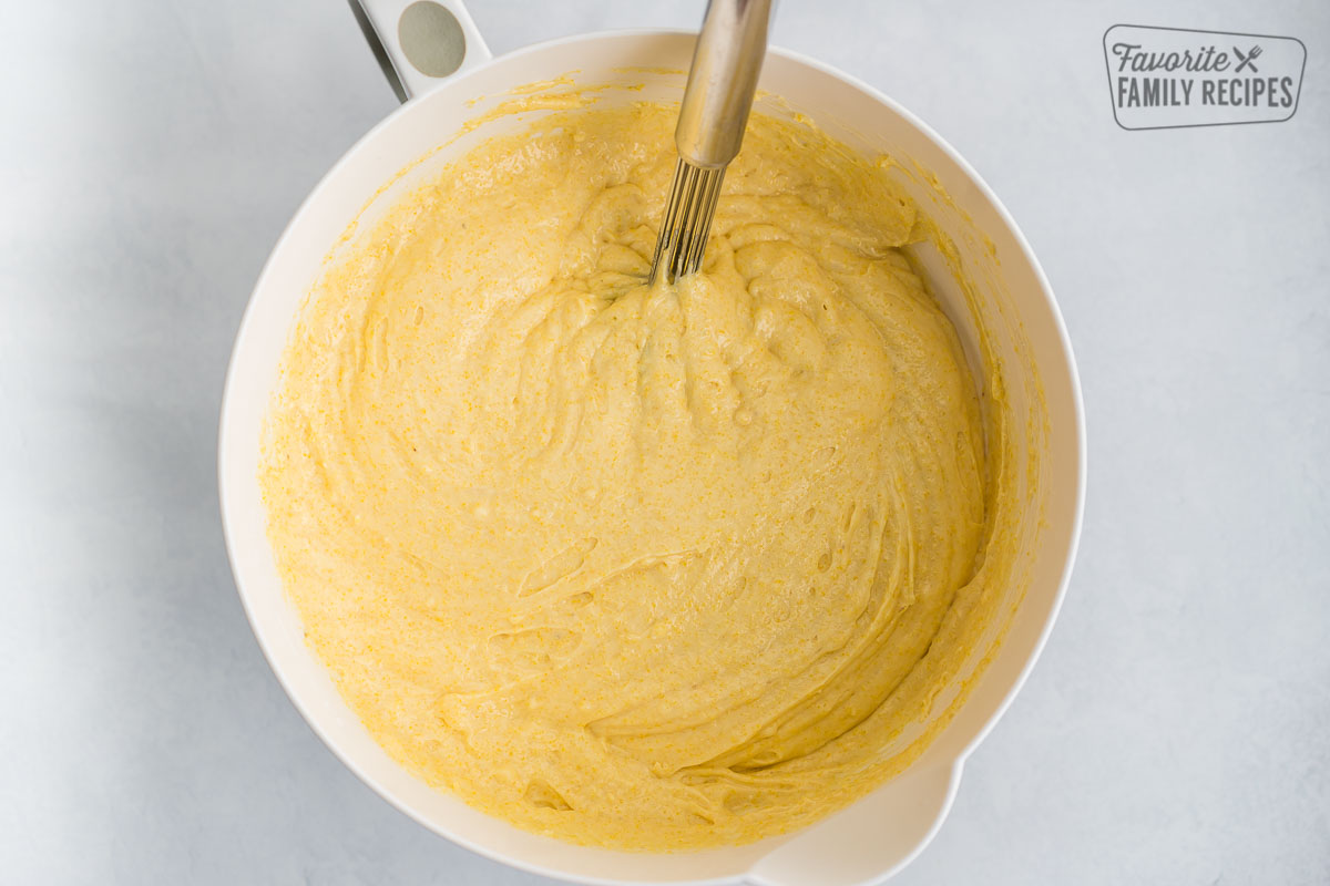 Cornbread batter in a bowl with a whisk