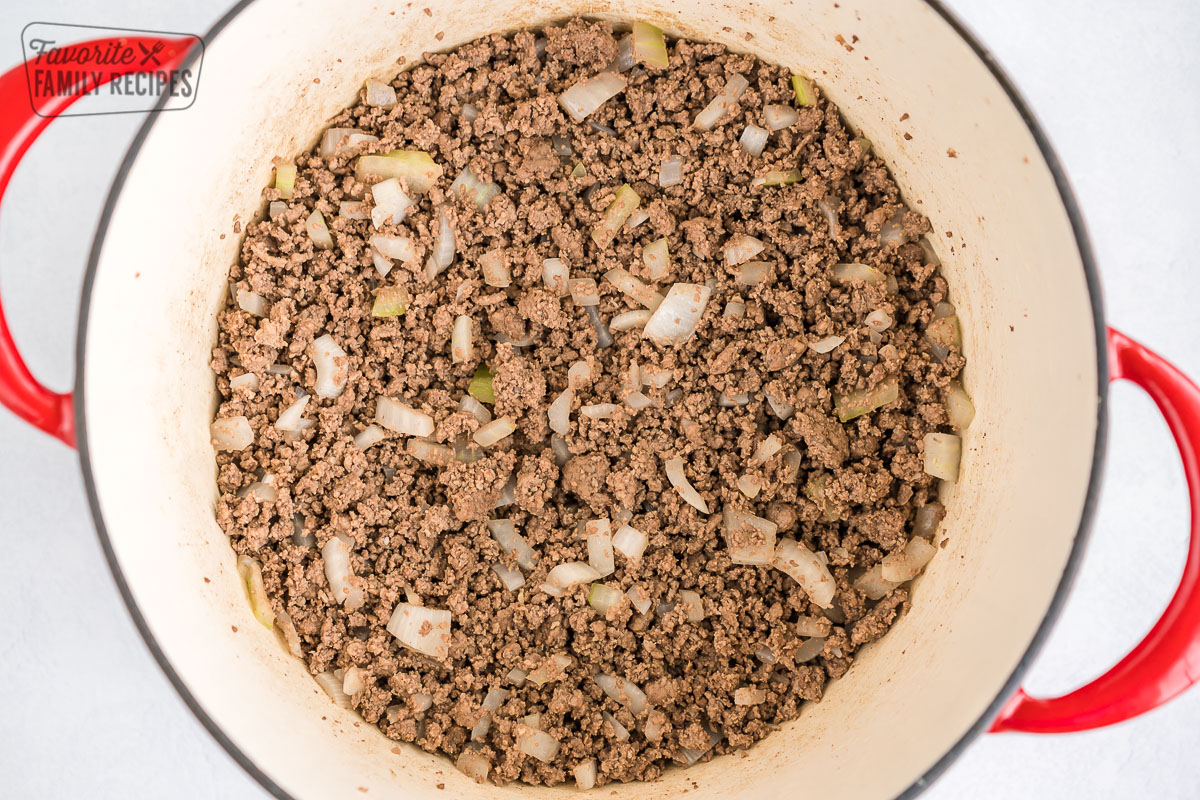 Ground beef and diced onion cooking in a pot
