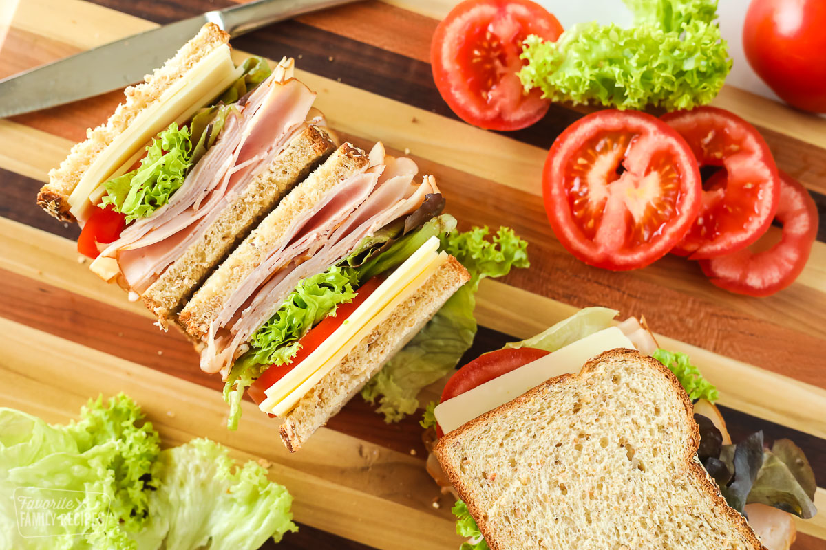 Turkey sandwich with toppings on a cutting board