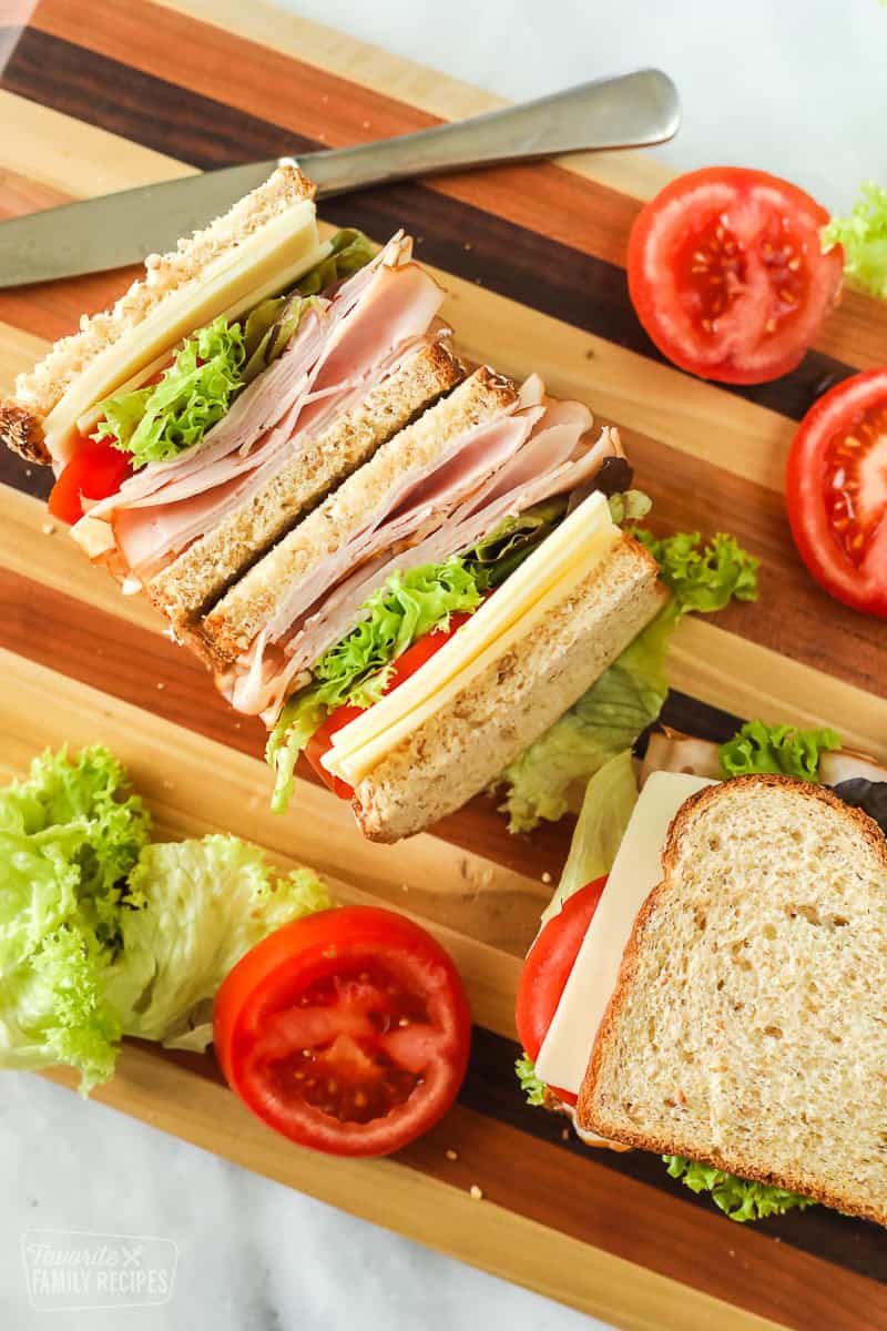 Turkey sandwich on a cutting board cut in half and facing up