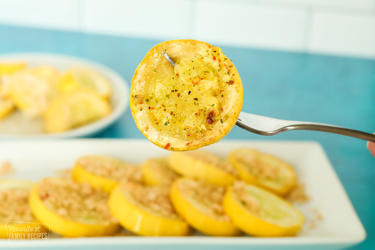 Close up of a slice of sautéed yellow squash with seasoning