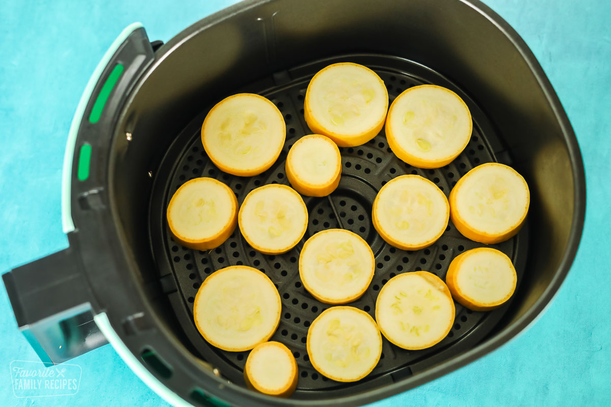 Sliced squash in an air fryer ready to be cooked