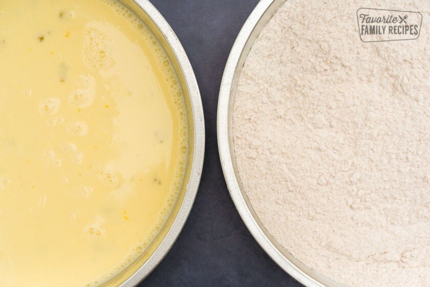 A pan with an egg wash and a pan with a flour mixture