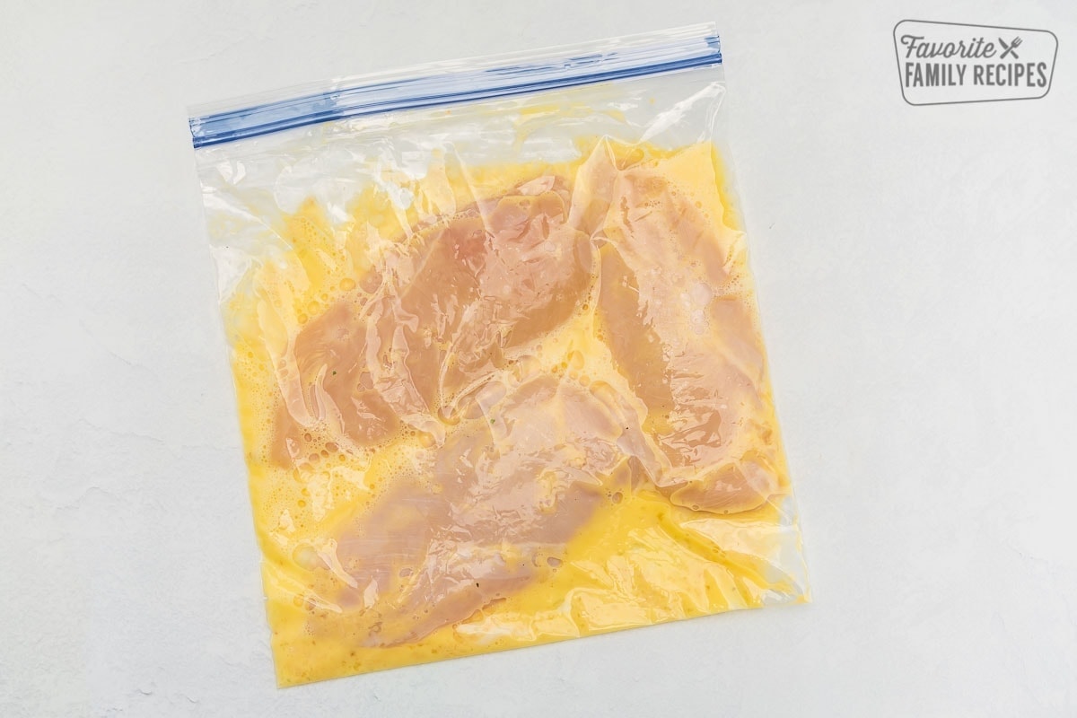 Chicken breasts in a ziplock bag with eggs and garlic