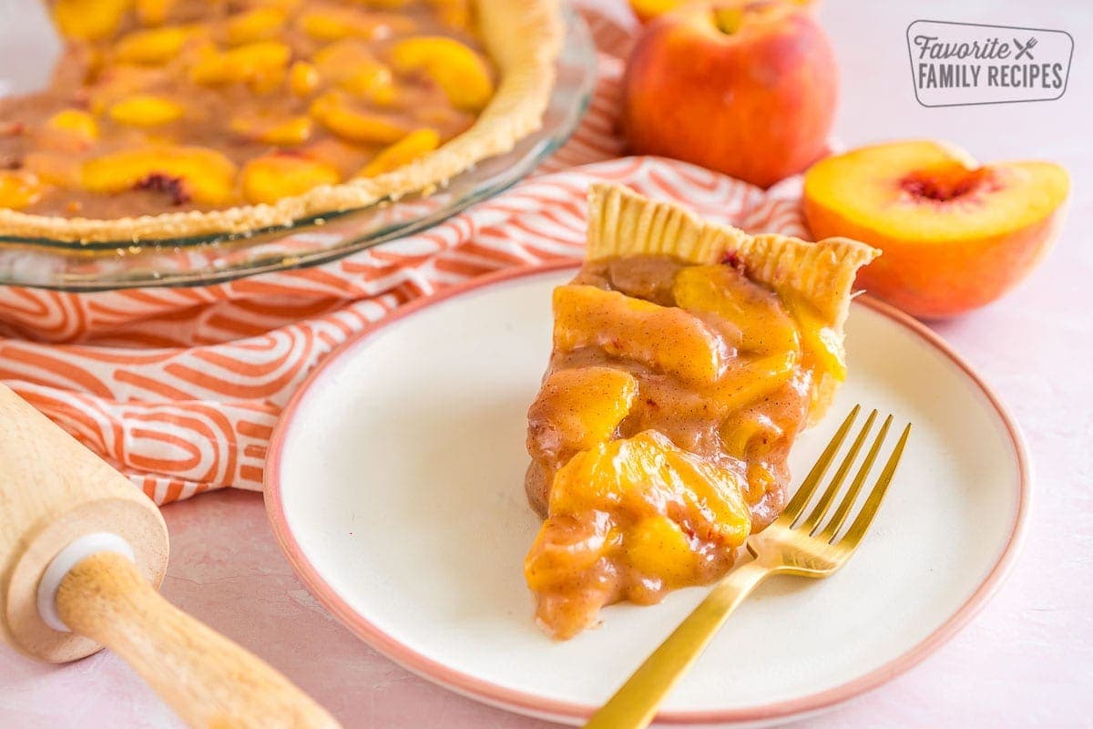 A slice of peach pie on a plate