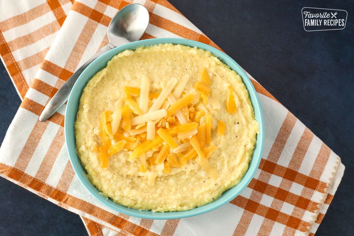 Cheese grits in a bowl with cheese sprinkled on top