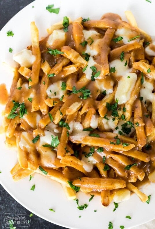 A plate of fries with gravy and cheese curds melted over the top (poutine)