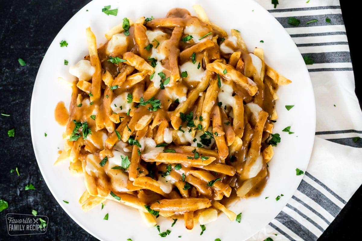 A place of poutine with fries, gravy, and cheese curds.