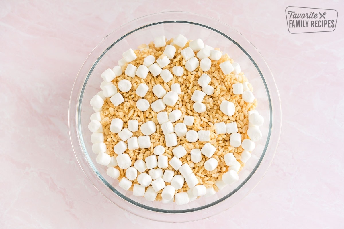 A glass bowl full of rice krispies and mini marshmallows