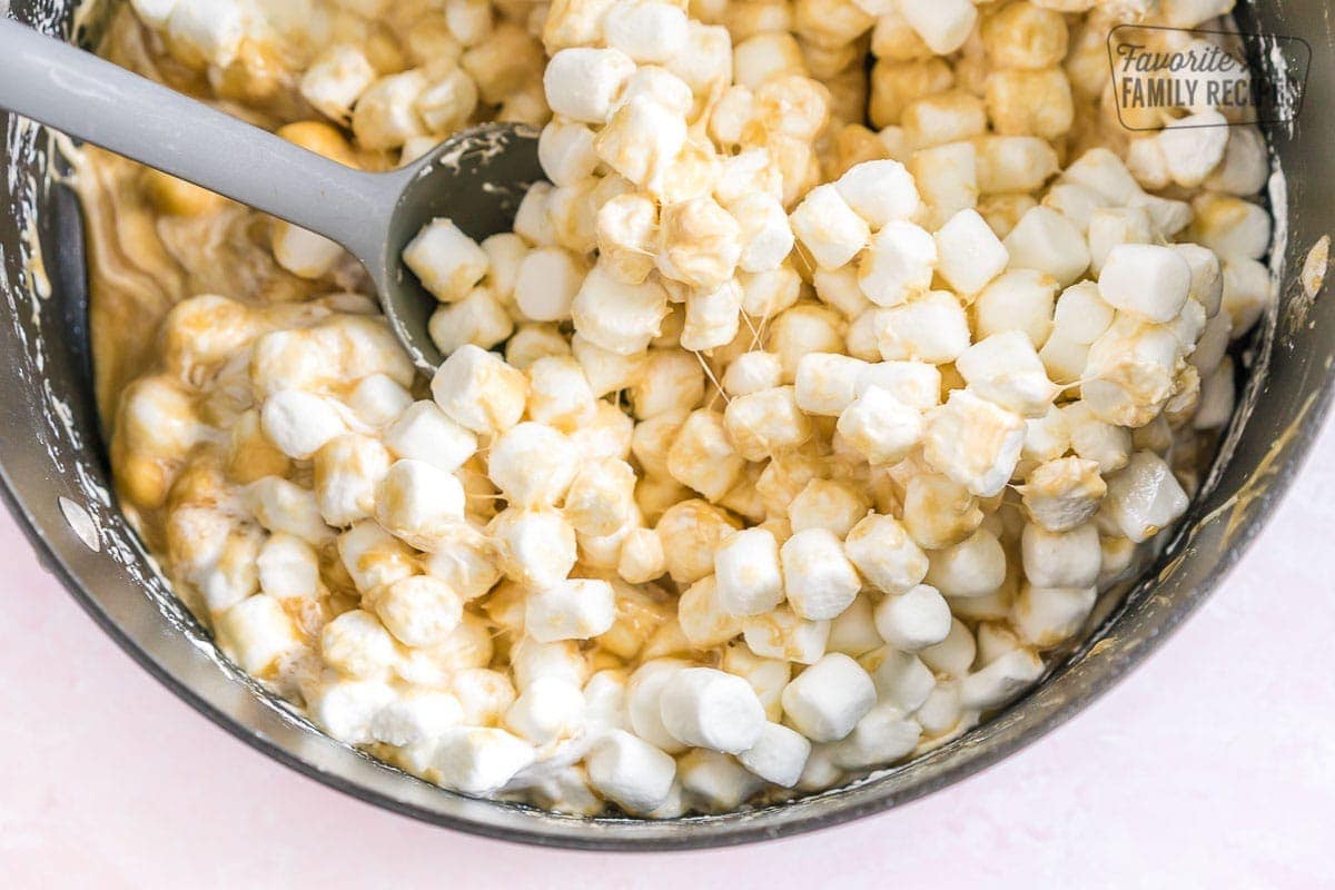 Marshmallows being mixed with caramel sauce