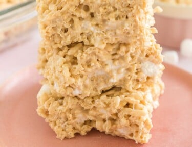 Three salted caramel rice krispie treats on a plate