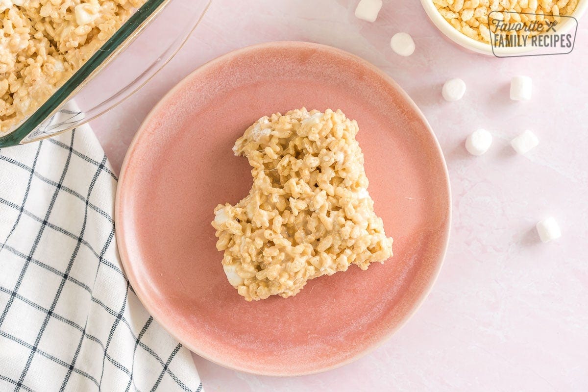 A salted caramel rice krispie treat with a bite taken out of it on a plate