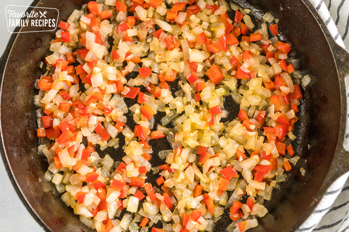 Peppers and onions and garlic in a cast iron pan