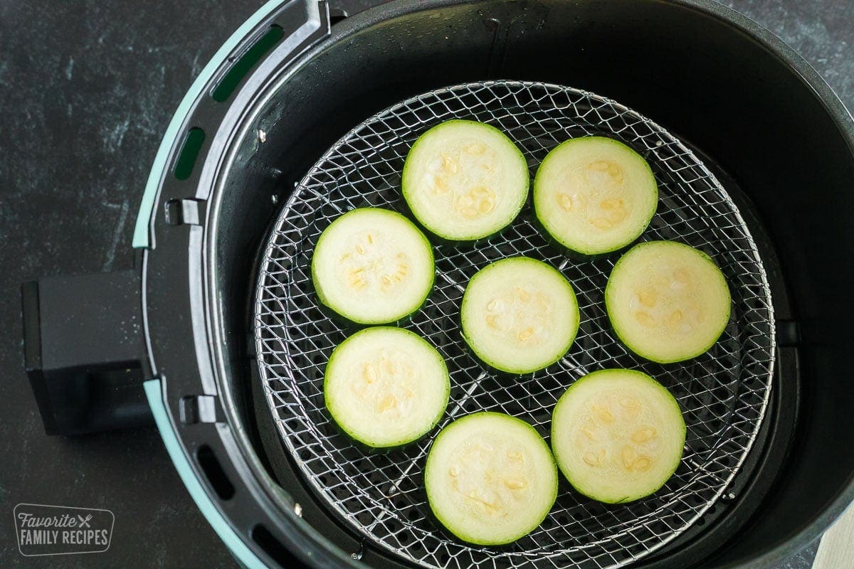 Slices of zucchini, uncooked, in an air fryer