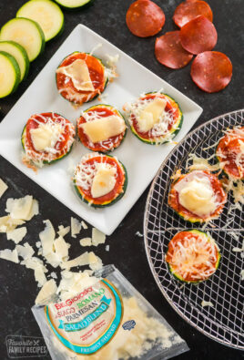 Slices of zucchini topped with pizza sauce, cheese, and pepperoni that has been cooked in the air fryer