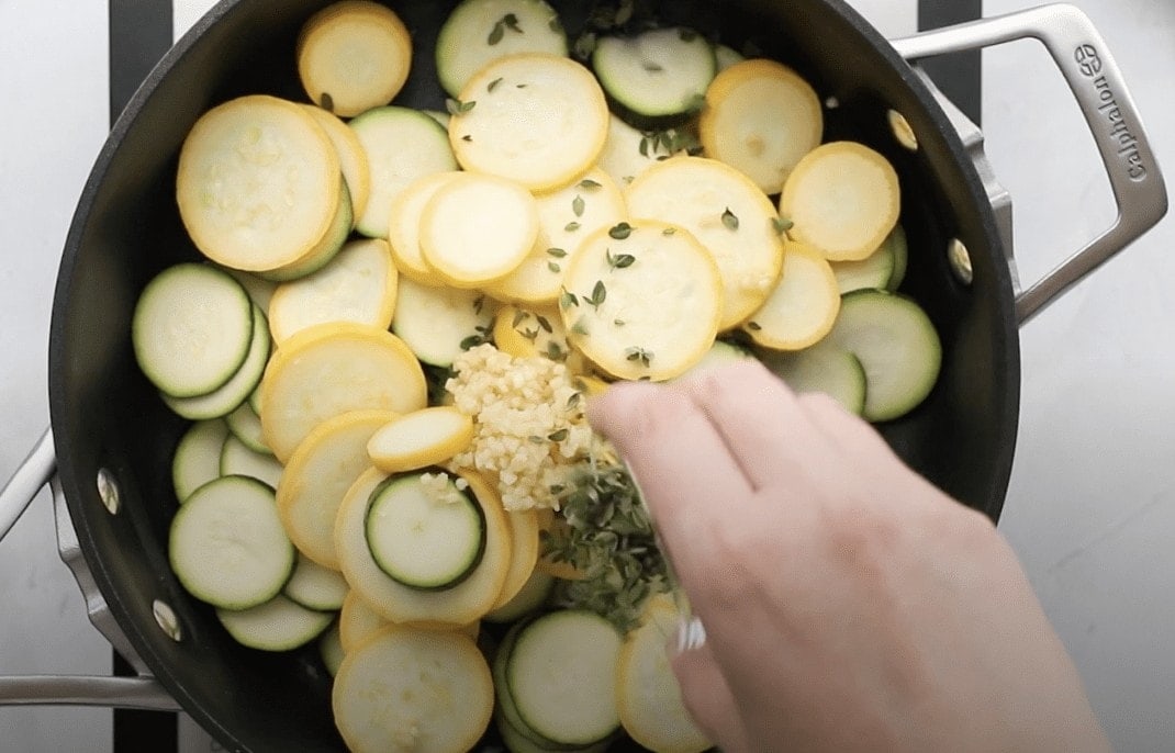 squash and zucchini in a skillet with thyme and garlic