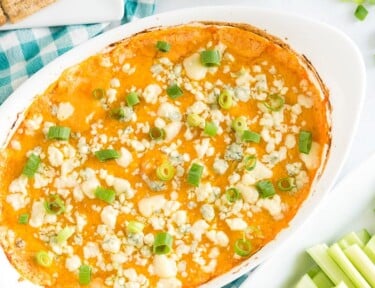 An oval baking dish full of buffalo chicken dip