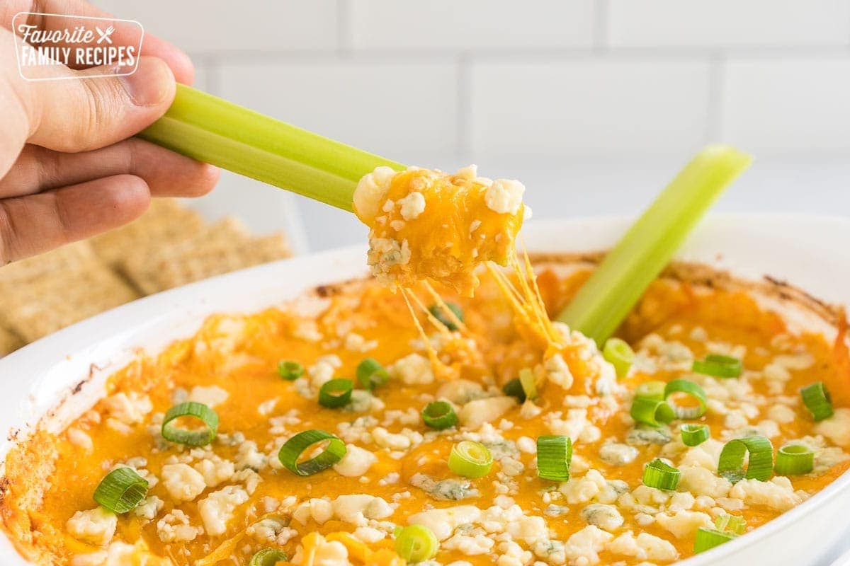 A celery stick scooping up some buffalo chicken dip