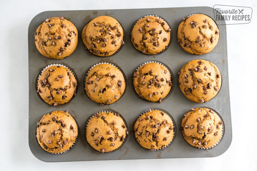 A muffin tin full with pumpkin chocolate chip muffins