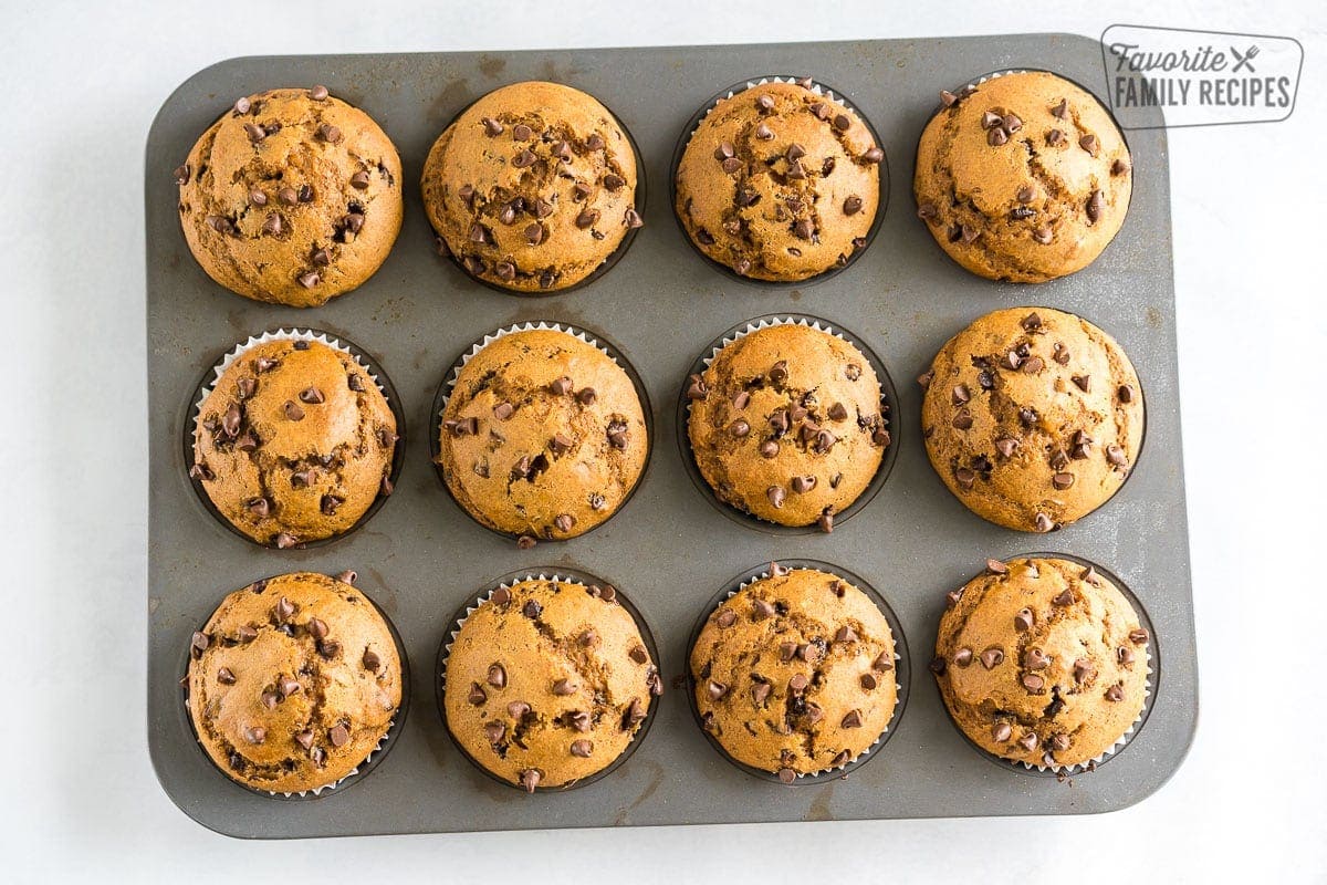 A muffin tin full with pumpkin chocolate chip muffins