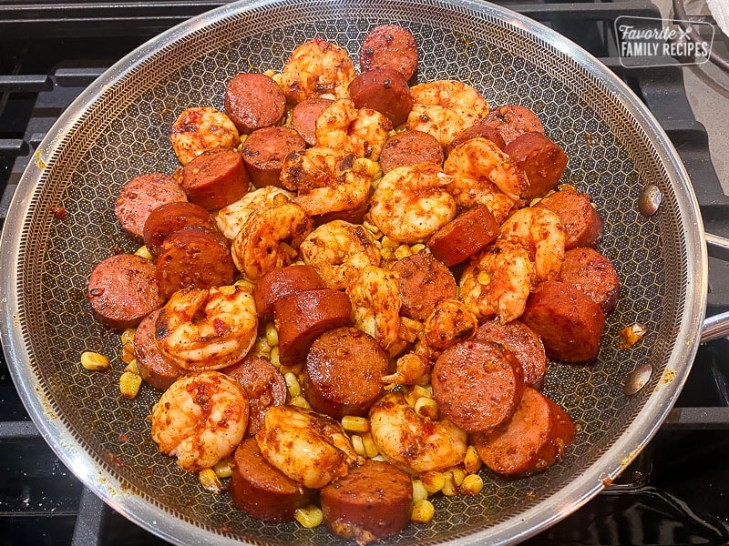 Shrimp, sausage, and corn, cooking in a fry pan