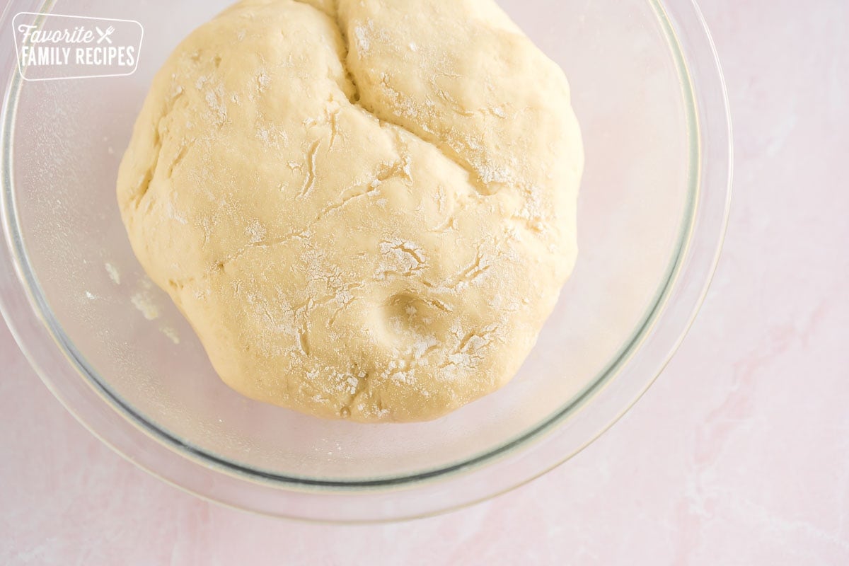 Risen dough in a glass bowl