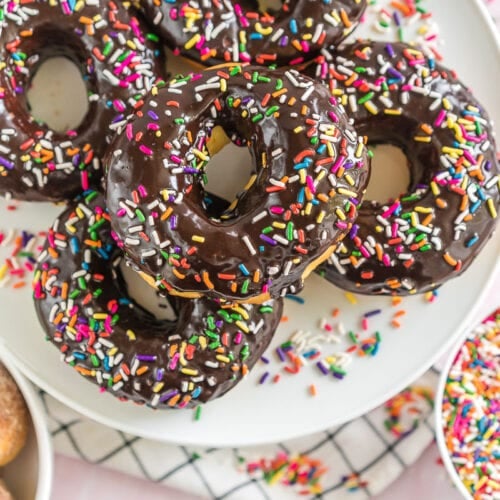 A platter of Air Fryer Donuts topped with chocolate icing and sprinkles