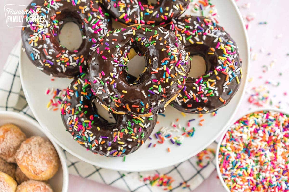 A platter of Air Fryer Donuts topped with chocolate icing and sprinkles.