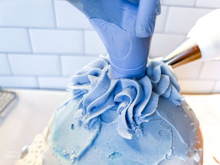 Close up of frosting being piped onto a Barbie cake to show color match