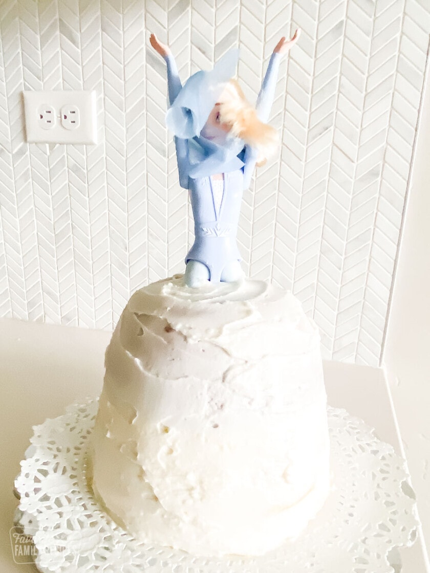 A cake shaped like a skirt for a princess Barbie doll with a simple layer of frosting.