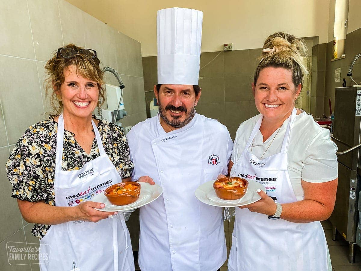 Echo, Erica, and Chef Carlo Ricci holding gnocchi. 