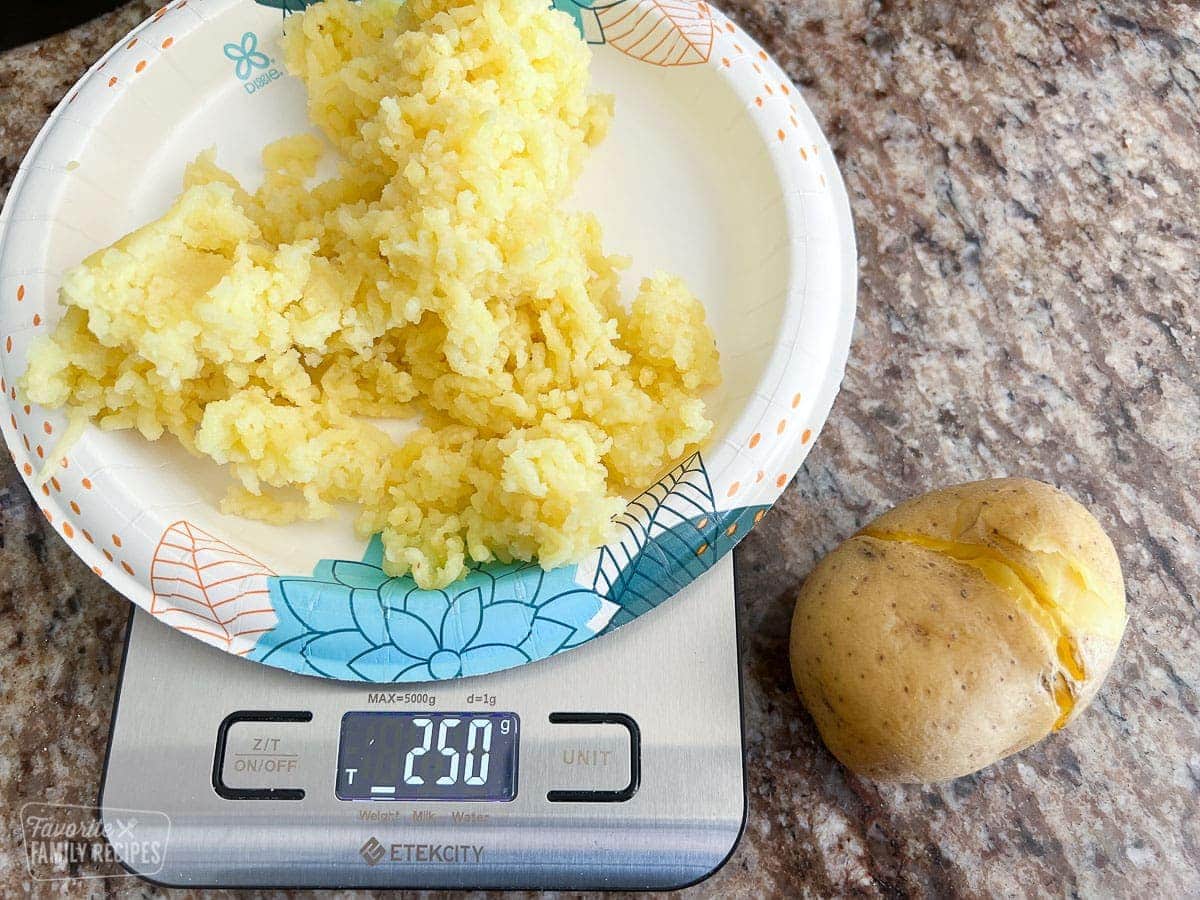 Riced potatoes on a kitchen scale showing 250 grams
