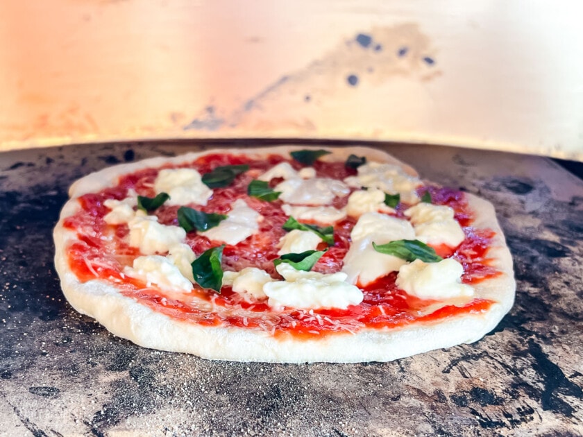 A Neapolitan style pizza in a pizza oven