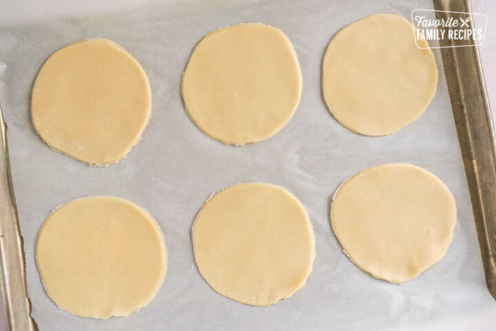 Circles of pie dough on a baking sheet
