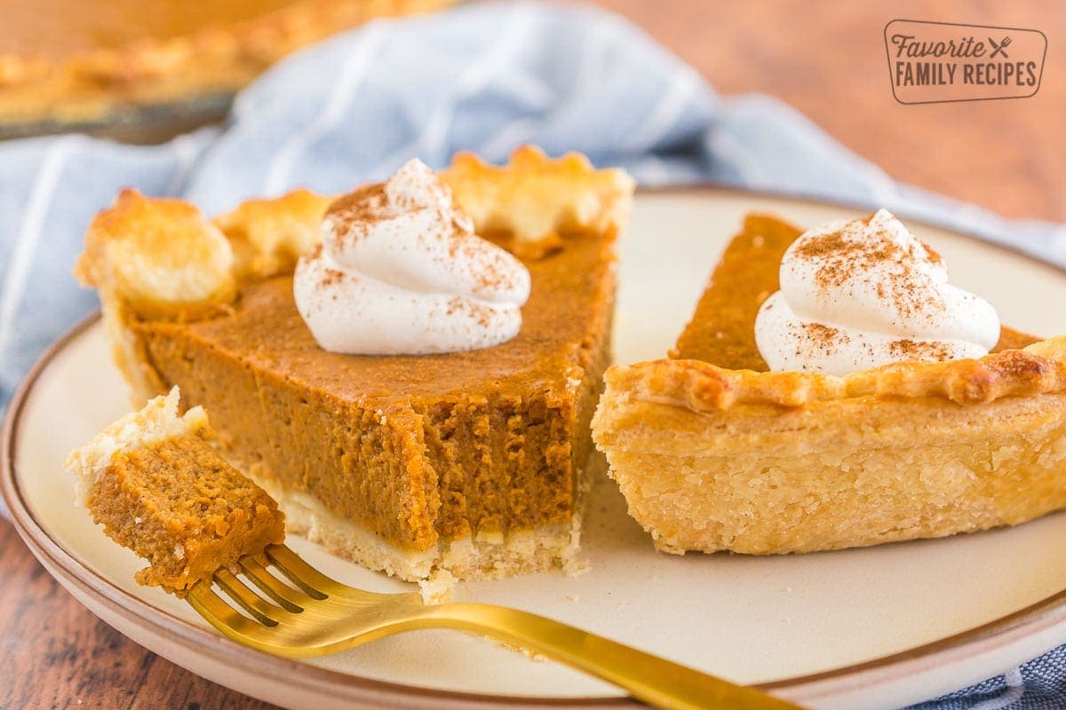 a slice of pumpkin pie with a bite taken out of it.